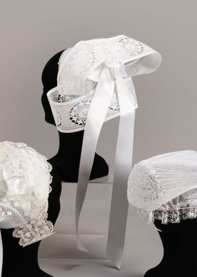 three hats that are sitting on top of a mannequin
