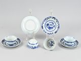 a group of blue and white dishes and cups and saucers