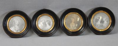 three oval black and gold picture frames with a picture of a man and a woman