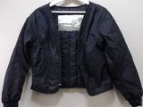 the jacket is hanging on a hanger on the wall