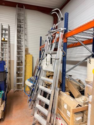 a ladder that is leaning against a wall in a warehouse