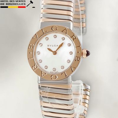 an image of a close up of a wrist watch on a white surface