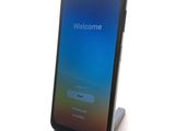 a phone that is sitting on a stand with a welcome screen