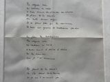 an old piece of paper with writing on it sitting on top of a table