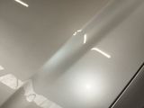 a close up of a car ' s hood with a light shining on it