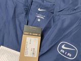 the jacket is blue and has a white logo on it