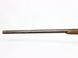 a close up of a gun with a wooden barrel on a white background