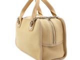 the small beige bag is sitting on a white surface