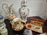 many different vases on a table with a small box