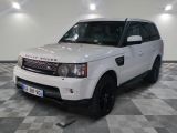 a picture of a white land rover parked in a garage