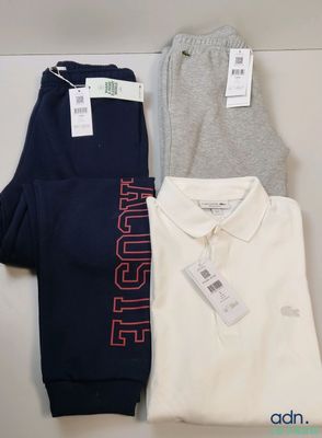 three men ' s polo shirts and pants are on a table