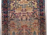 an antique persian rug with a floral design on a blue ground