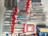 a lot of different types of ink and cartridges on the table