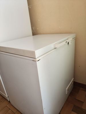a white refrigerator in the corner of a room