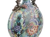 a vase with a floral design on it on a white background