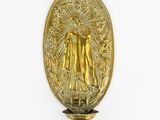 brass plaque of the virgin of guadalupe on a white background