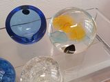 a glass display case with a variety of glass vases on it