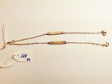 a close up of a necklace with a tag attached to it