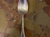 a spoon sitting on a marble table with a spoon on it