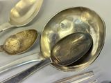 a lot of silver spoons and spoon spoons on a table