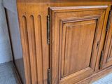 a wooden cabinet with a glass door on top of it