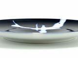 a black and white bowl with a bird on it