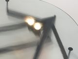 a glass table with a clock on top of it