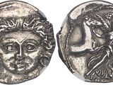 a silver coin with an image of a woman and a man on it