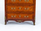 a small chest of drawers that is made of wood