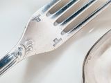 a fork and a spoon on a white plate