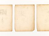 three old books with drawings on them sitting on a white surface