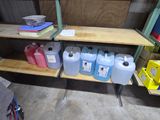 a shelf with several containers of different colors and sizes on it