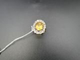 an image of a close up of a yellow and white diamond ring on a black surface