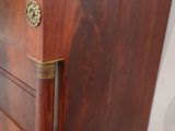a wooden cabinet with a marble top in a room
