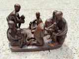 a statue of a group of people sitting on a boat