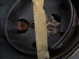 an old black helmet with a yellow ribbon around it