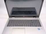 a laptop computer that is open on a white surface
