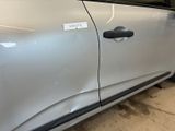 a silver car with a sticker on the side of it