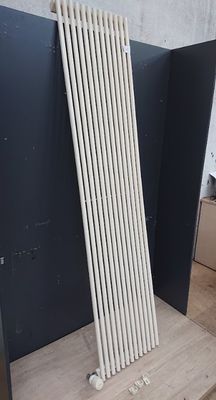 a radiator that is sitting on the floor next to a wall