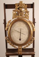 Baromètre thermomètre de forme ovale, en bois richement moul…
