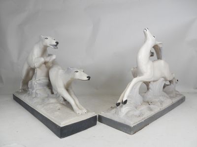 pair of white ceramic sculptures of a polar bear and a polar bear