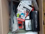 a cardboard box full of electronics and other items