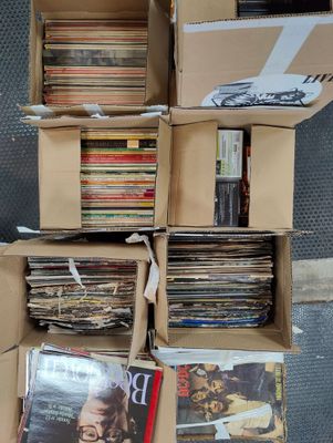 boxes full of records stacked on top of each other on the floor