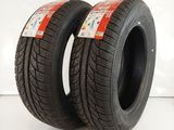 a pair of tires on a white surface with a red label