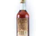 a bottle of whiskey sitting on top of a white surface