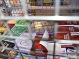 a shopping cart full of cigarettes in a store