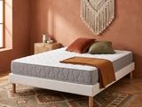 an image of a bedroom with a bed and a rug on the floor