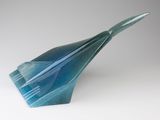 a blue paper airplane that is sitting on a table