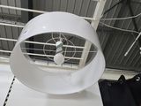 a fan that is hanging from the ceiling in a room
