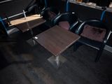 three chairs and a table in the corner of a room